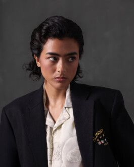 Medhavi Chettri, represented by ALF modeling agency, in a sharp black blazer with embroidered Almost Gods crest and printed shirt for the brand’s campaign. 