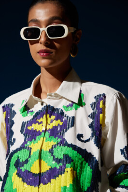 Model Akriti Jha wearing a sequined white shirt with bold green, yellow, and purple patterns for Mohammed Mazhar campaign 